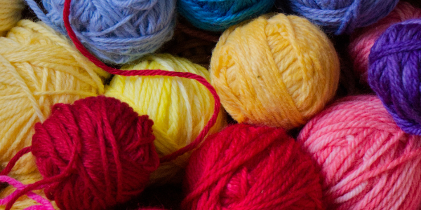 A pile of different coloured wools